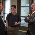 Doctor Potteiger laughing with some guests at the Graduate Showcase